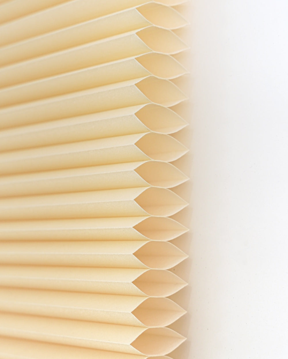 No drill honeycomb shades in soft cream fabric, featuring cordless pleated cells and a clean, streamlined design