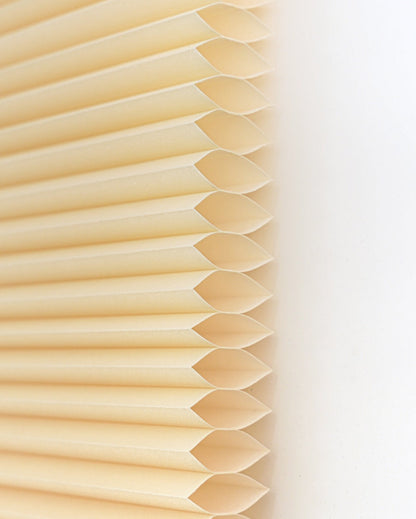 No drill honeycomb shades in soft cream fabric, featuring cordless pleated cells and a clean, streamlined design