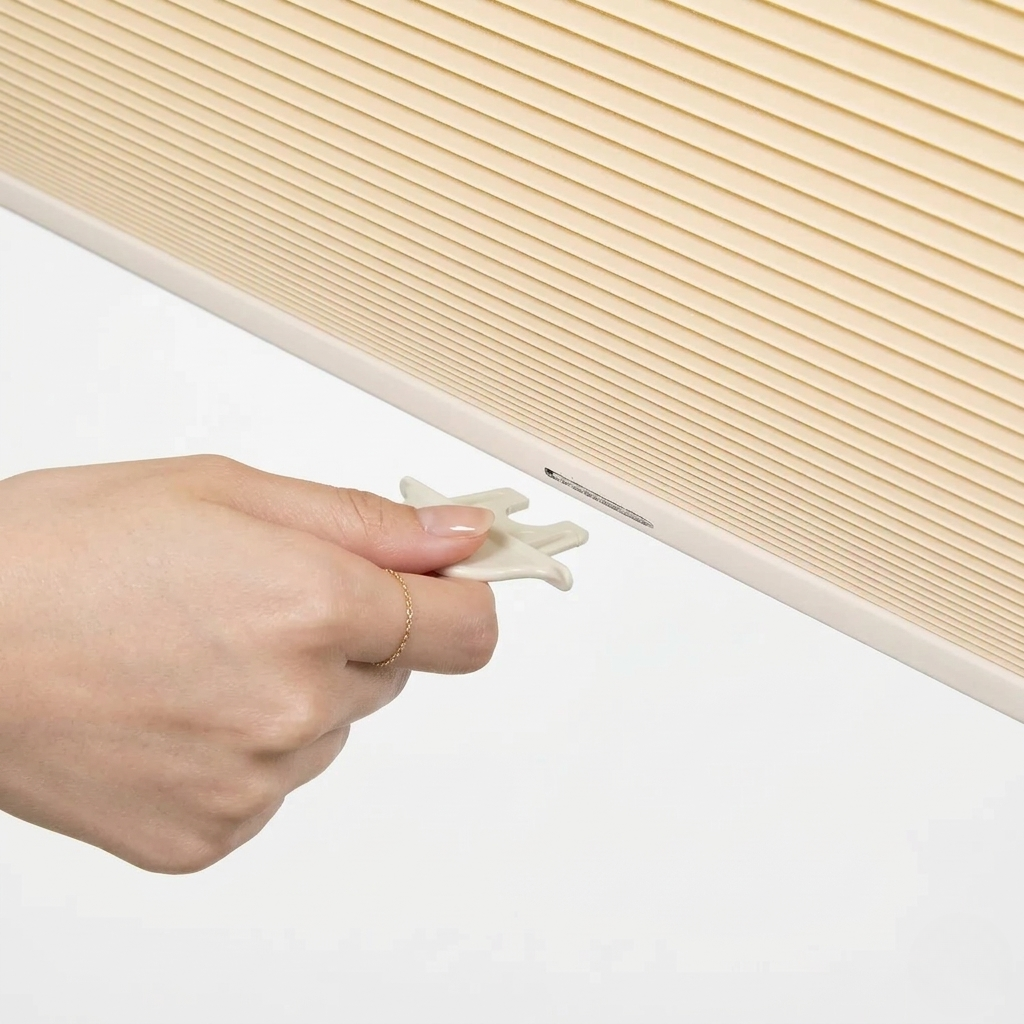 No drill honeycomb shades in light beige fabric with pleated texture and cordless tool-free mounting clip system