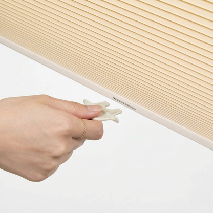 No drill honeycomb shades in light beige fabric with pleated texture and cordless tool-free mounting clip system