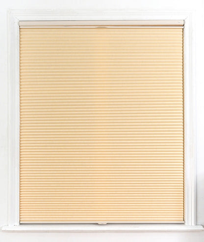 No drill honeycomb shades in warm beige fabric, featuring a cordless pleated design for windows