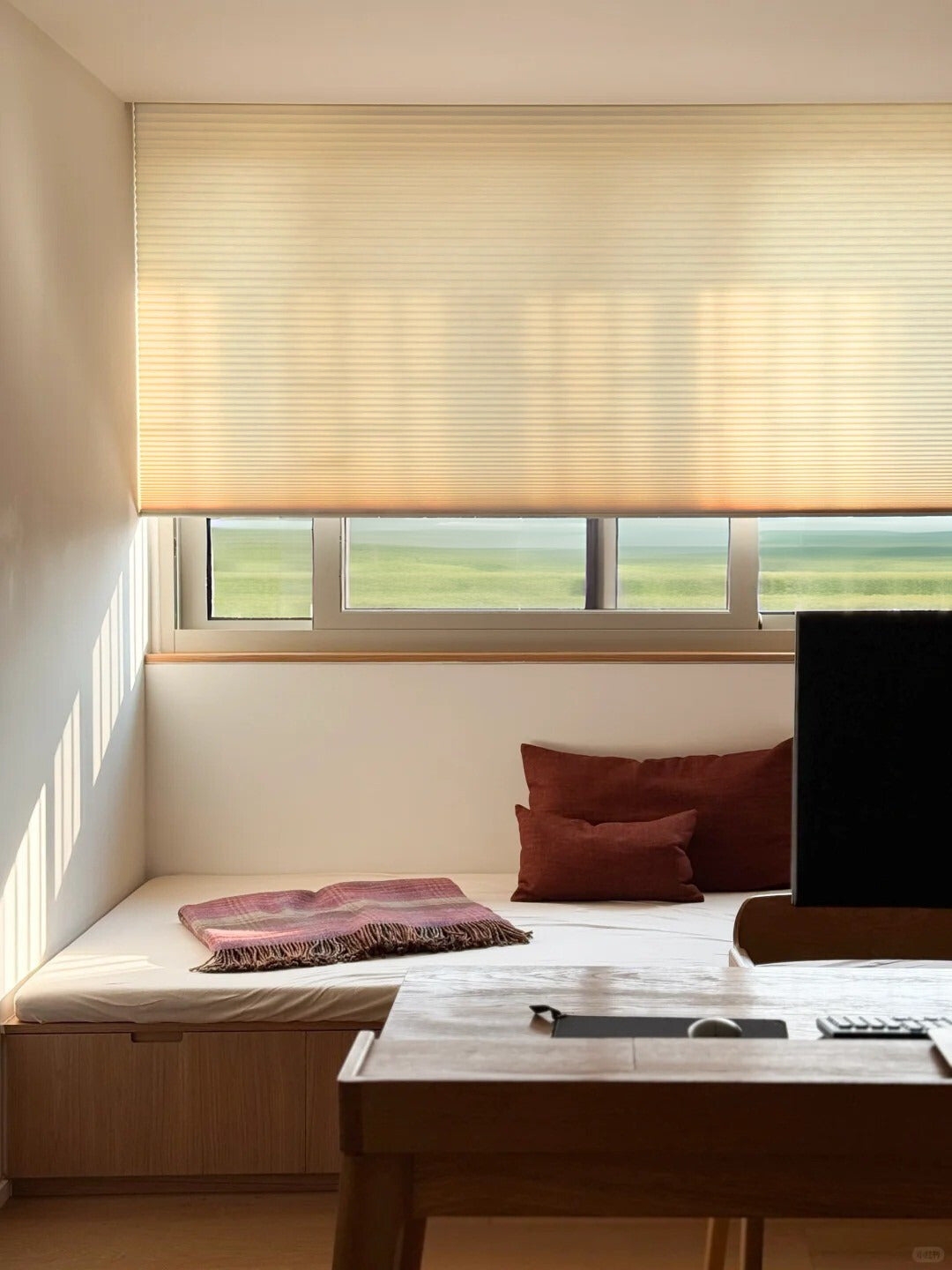 No drill honeycomb shades in warm beige fabric, featuring a cordless design and pleated cellular texture.