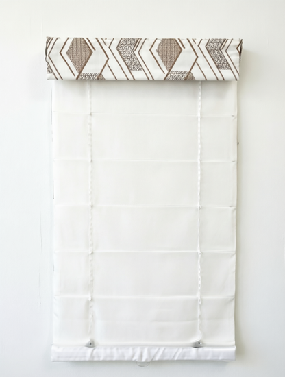 Patterned Roman Shades in white linen with raised geometric embroidery and a flat-fold design; cordless lift system visible.