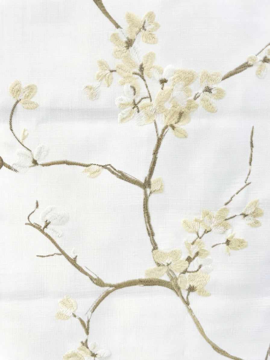 Patterned Roman Shades in ivory linen with raised French embroidery, featuring delicate flowering branches and blossoms