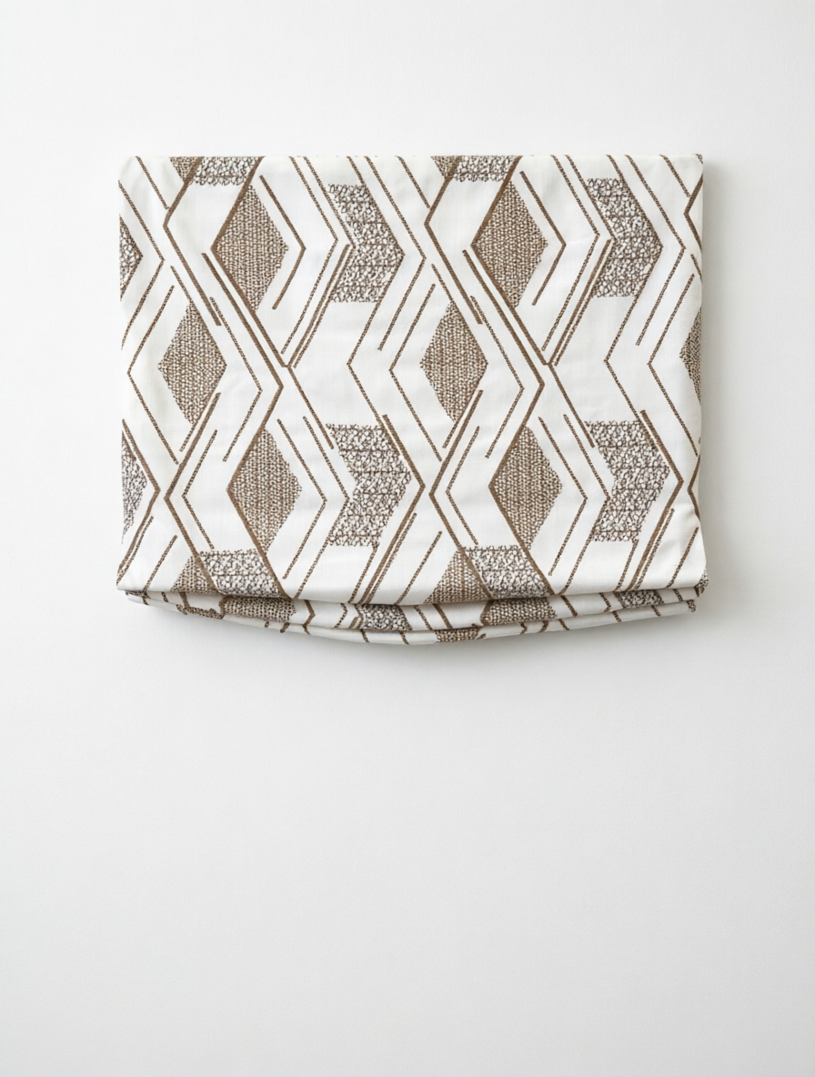 Patterned Roman Shades in cream linen with taupe embroidered geometric diamond pattern and flat fold design