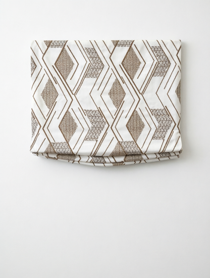 Patterned Roman Shades in cream linen with taupe embroidered geometric diamond pattern and flat fold design