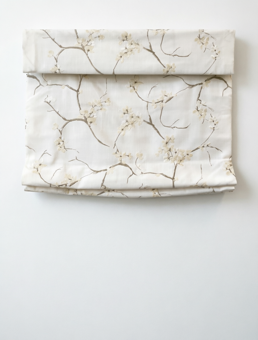 Patterned Roman Shades in cream linen with raised French embroidery, featuring delicate branches and blossoms in flat folds