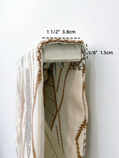 Patterned Roman Shades in cream linen with raised brown embroidered detailing and a concealed cordless mechanism