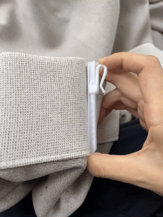 Pinch pleat curtains with adjustable hooks gliding on a track