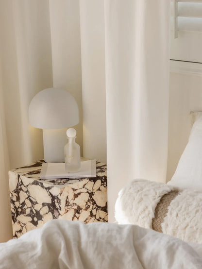 White sheer curtain hanging in a bright room providing privacy and natural light filtration