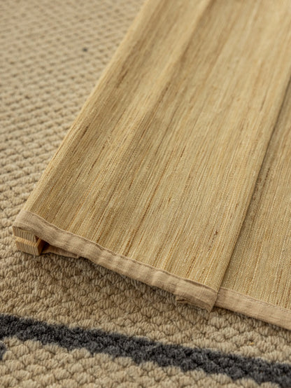 Natural custom bamboo shades in cashew with mildew-resistant ramie weave, soft texture, and handmade craftsmanship