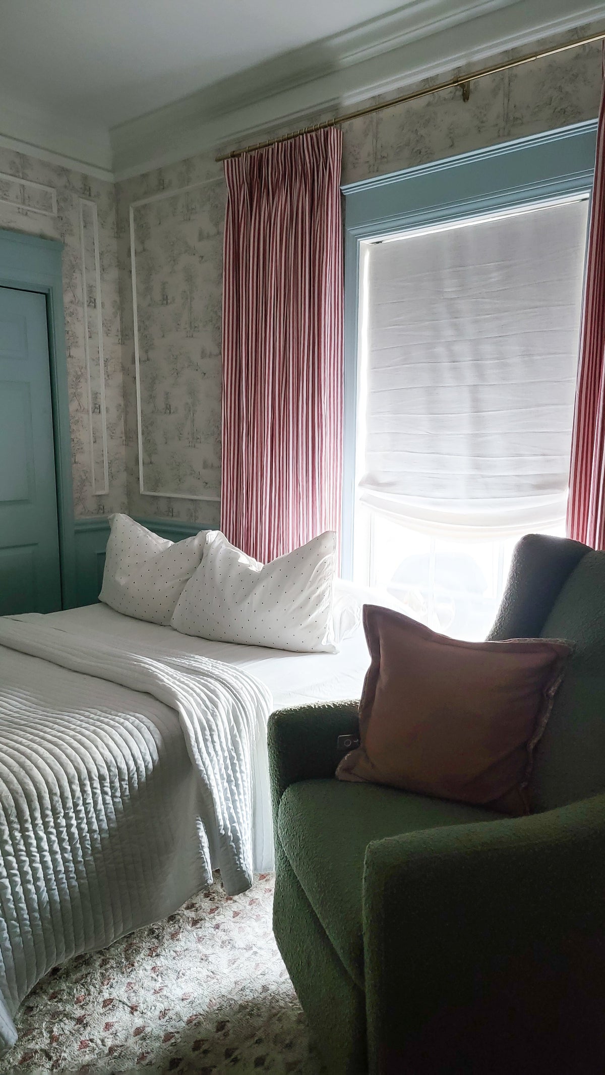 Relaxed Roman shades on window with soft curved bottom, light filtering linen fabric in modern bedroom setting