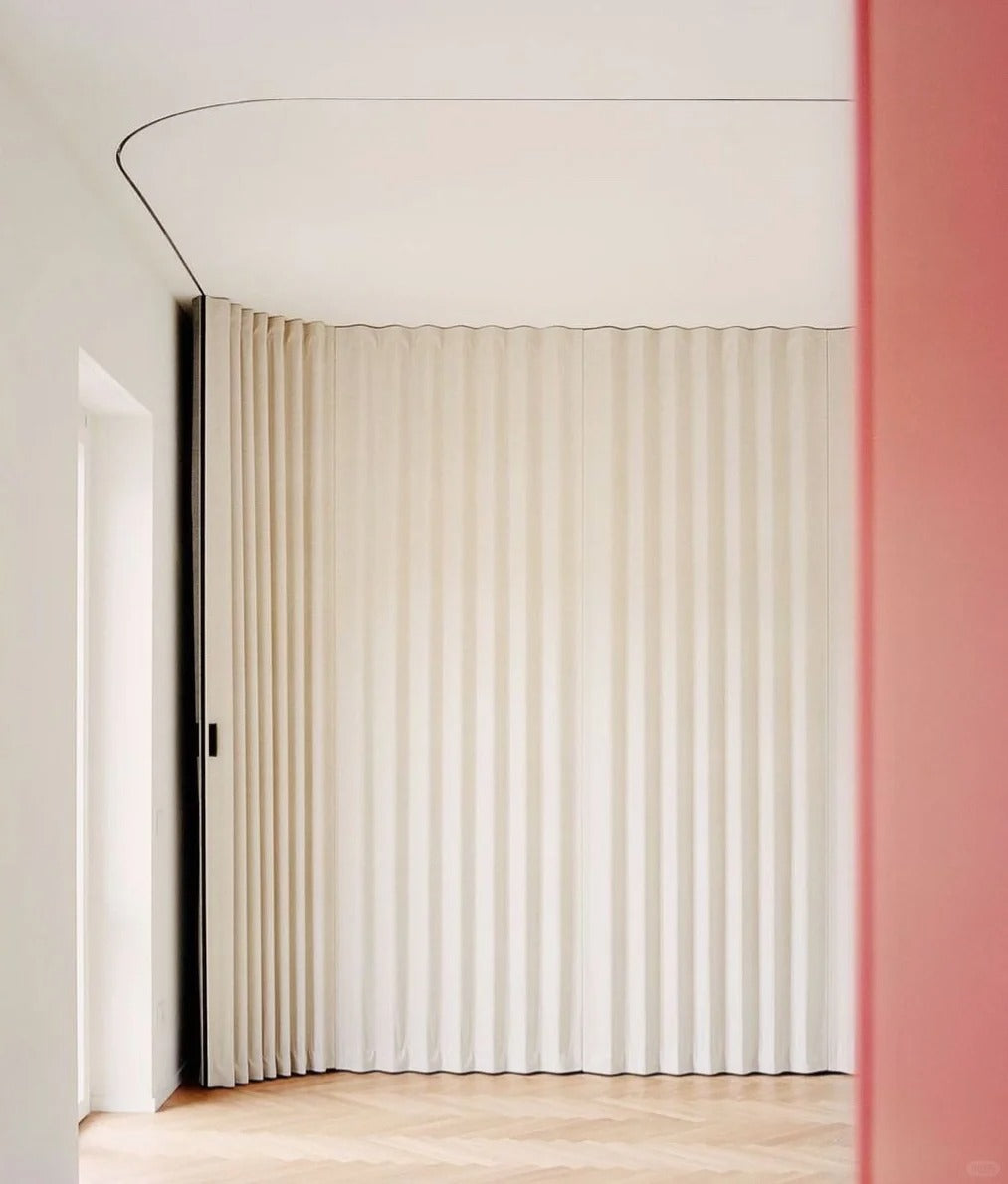 Ripple fold drapes on a ceiling track with evenly spaced soft waves in a modern room