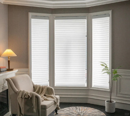 Light-filtering corded Shangri-La sheer shades with adjustable horizontal fabric blades for privacy and soft light diffusion in large windows
