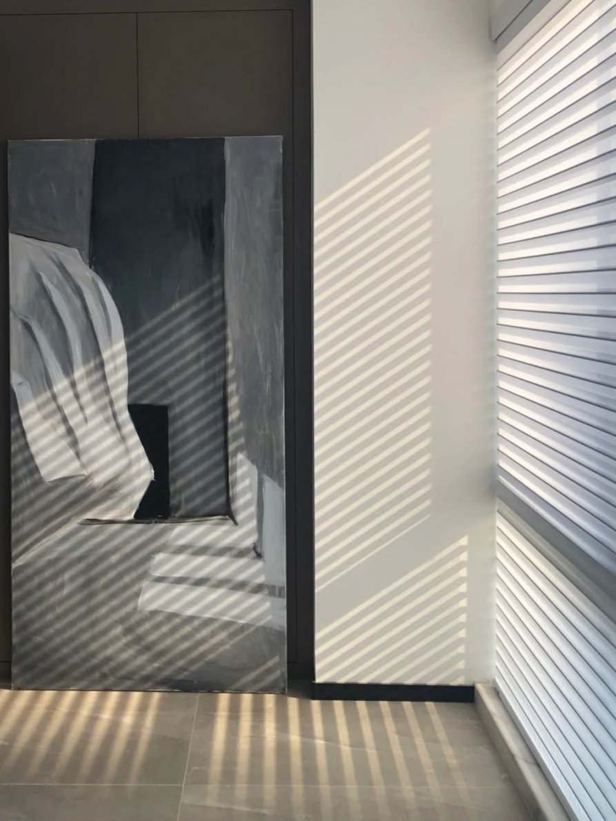 Light-filtering corded Shangri-La sheer shades with adjustable horizontal fabric blades for light control and privacy in large windows