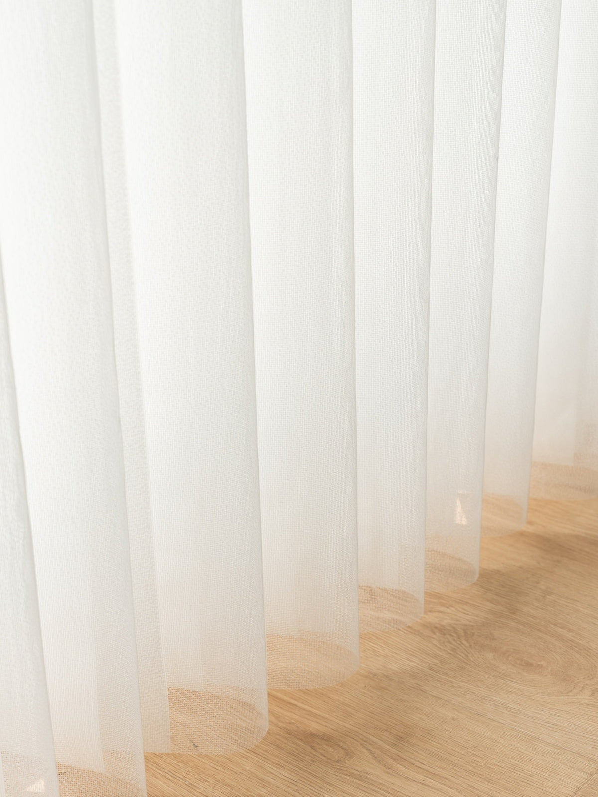 Vertical premium sheer curtain panels sliding horizontally with adjustable vanes on large sunny windows