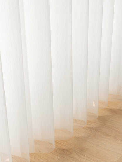 Vertical premium sheer curtain panels sliding horizontally with adjustable vanes on large sunny windows