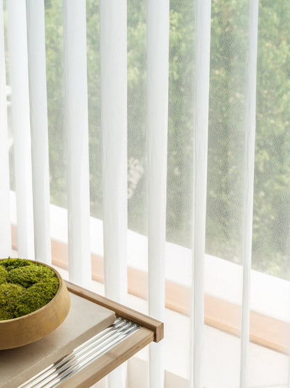 Sheer curtain panels sliding on track with adjustable vanes for light diffusion and privacy in large windows