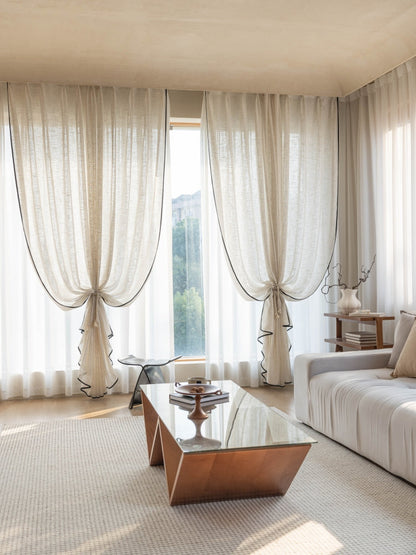 Sheer linen curtains filtering soft sunlight in elegant living room windows