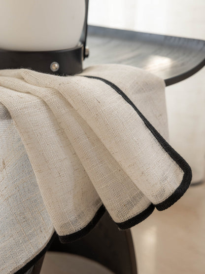 Lightweight sheer linen curtains softly filtering sunlight in a living room window