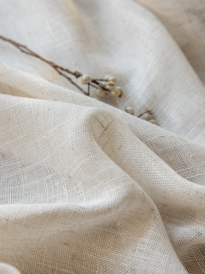 Sheer linen curtains filtering soft sunlight in a living room window