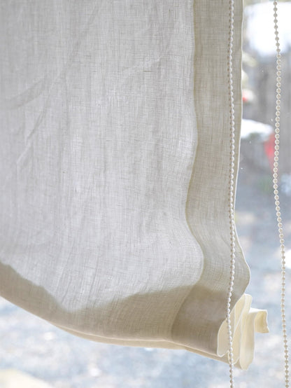 Sheer Roman shade in 100% pure linen softly filtering light and providing privacy with gentle folds