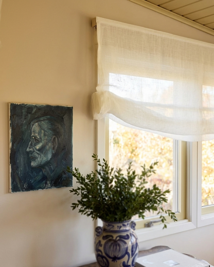 Sheer Roman shade in 100% pure linen fabric softening natural light with gentle folds