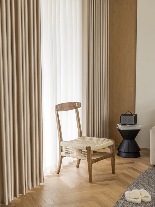 Luxurious heavyweight silk curtains draping smoothly with light, showcasing their glowing texture and easy maintenance qualities