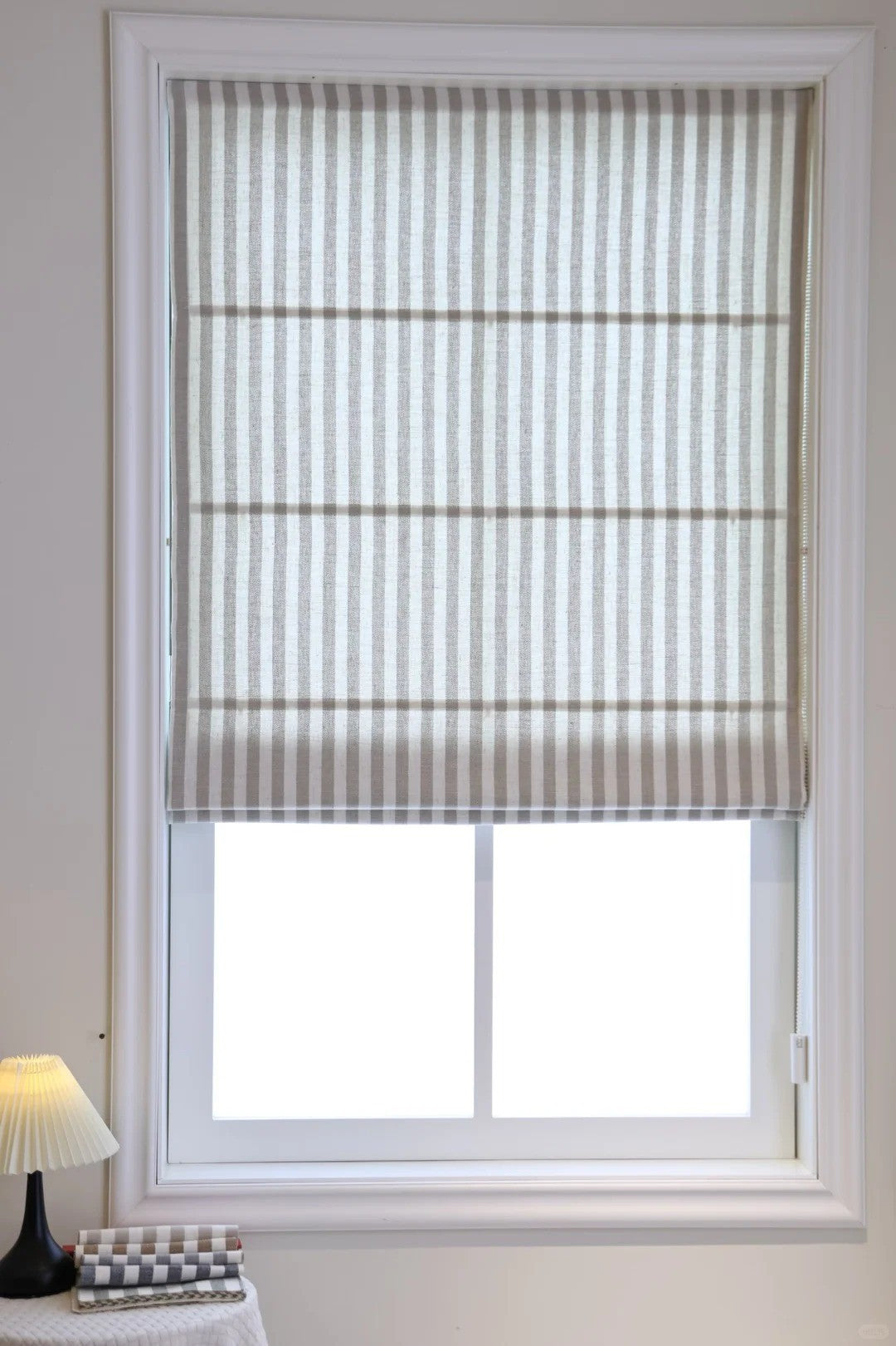 Classic striped roman shades with cordless lift, available in light filtering and blackout options, enhancing child safety and modern décor.