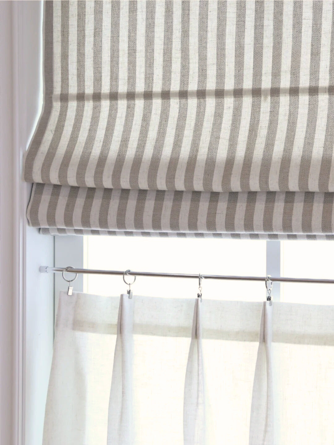 Cordless striped roman shades with light filtering and blackout options, designed for child safety and stylish home décor.