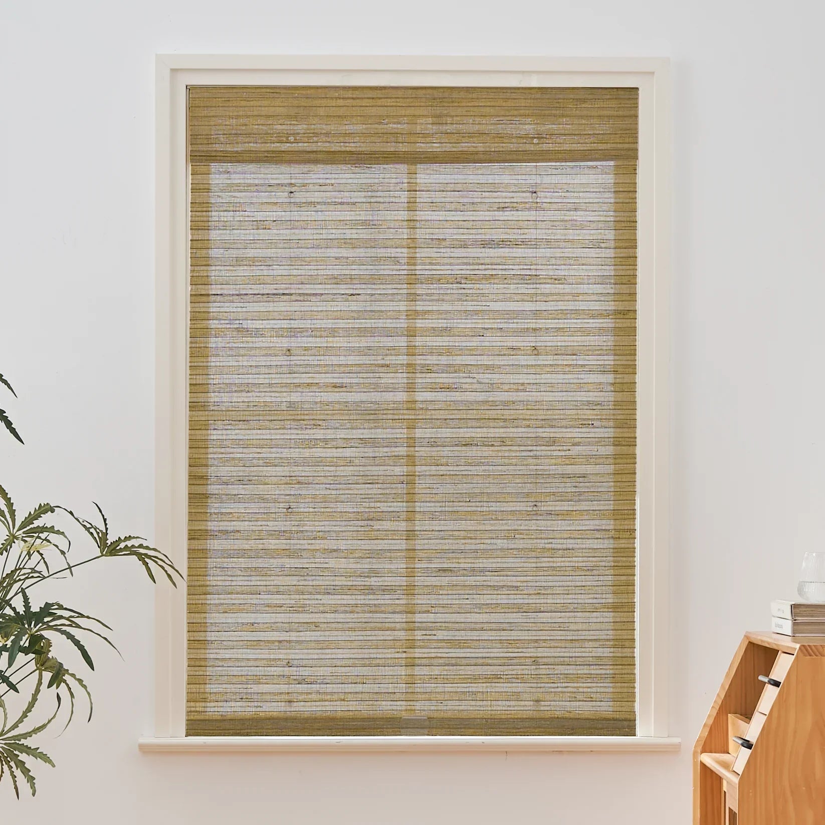 Natural hemp outdoor bamboo shades in beige brown with Roman design in window setting.