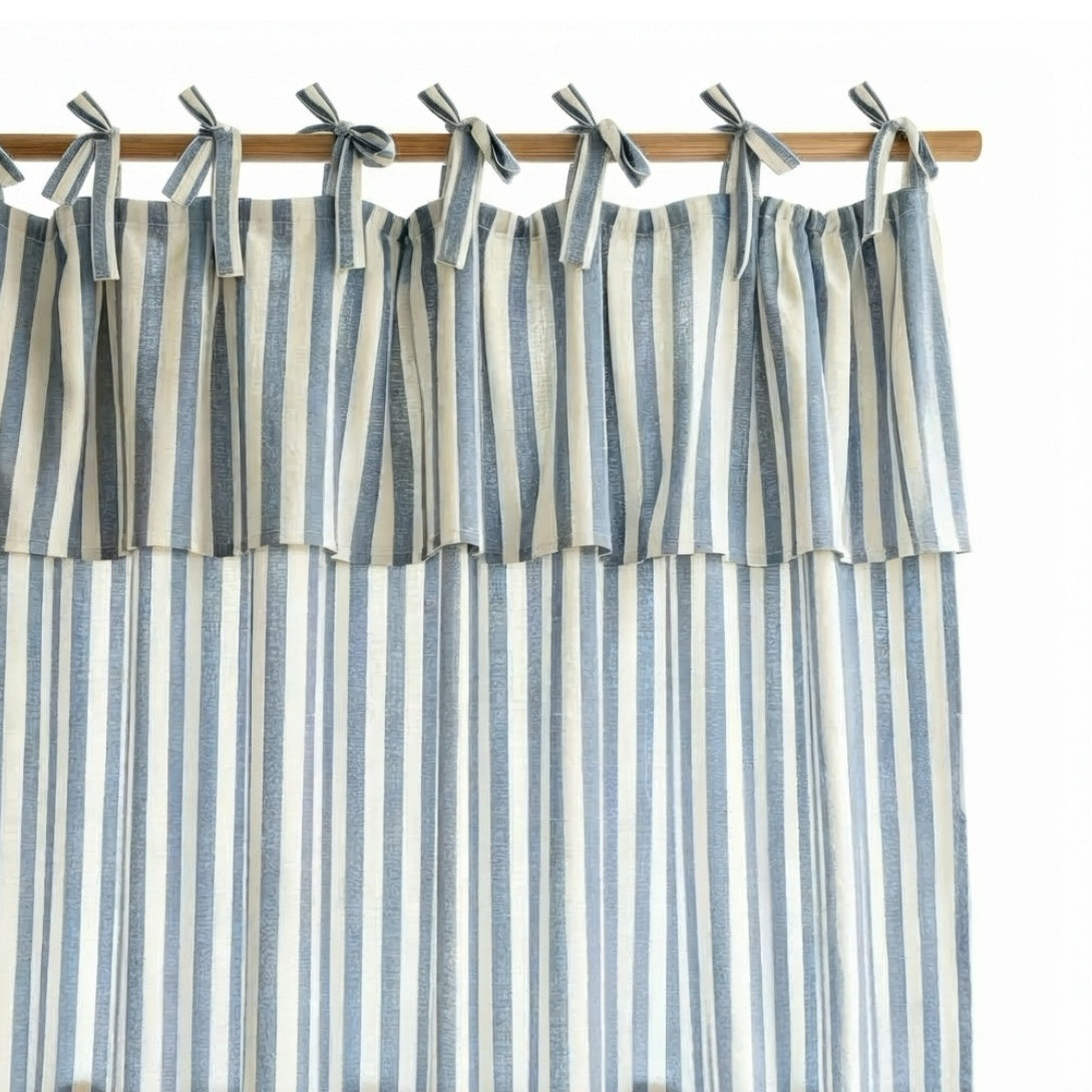 Blue and white striped linen tie top curtain with valance tied on a wooden rod