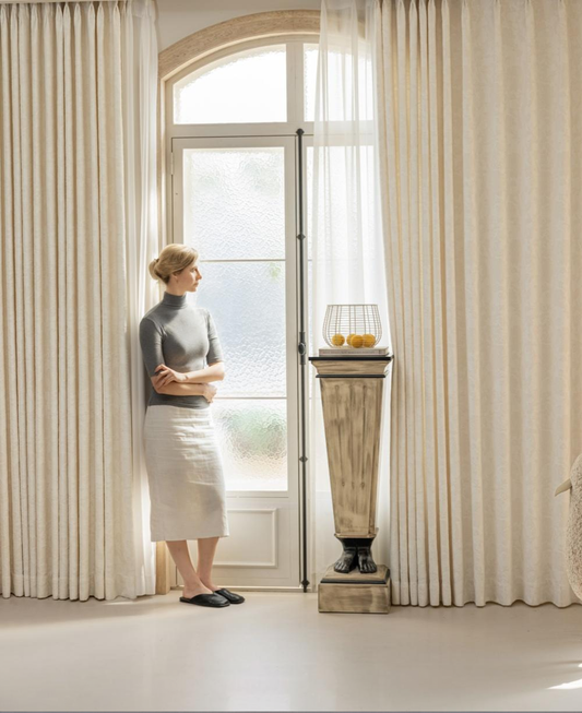 French embossed white blackout curtains in a living room setting.