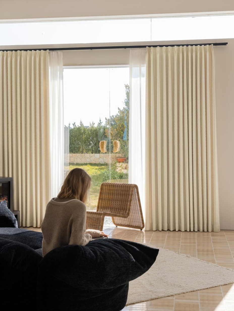 White blackout curtains with subtle stripes in a modern living space.