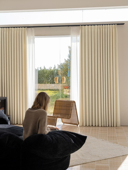 White blackout curtains with subtle stripes in a modern living space.