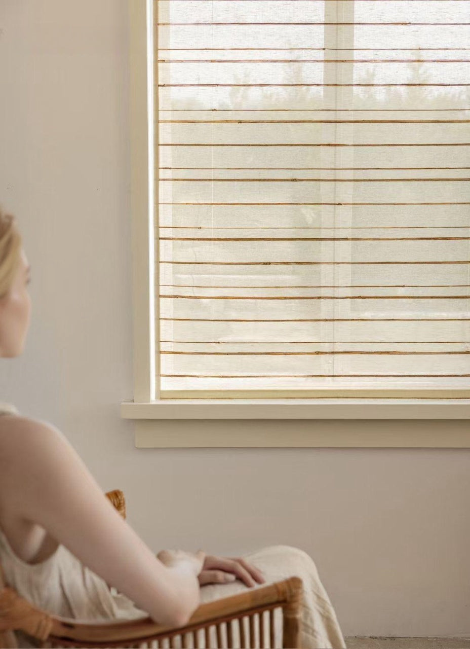 Natural Ramie Bamboo Blinds Woven Shades on a window, creating a calming atmosphere in a sunlit room.