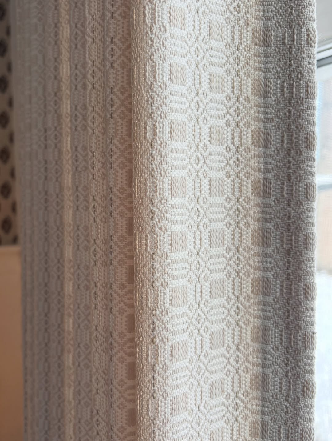 Vintage curtains in a taupe and ivory woven fabric, featuring a raised geometric medallion pattern and textured drape