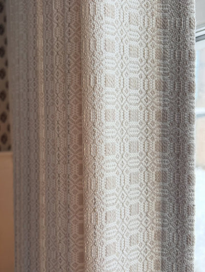 Vintage curtains in a taupe and ivory woven fabric, featuring a raised geometric medallion pattern and textured drape