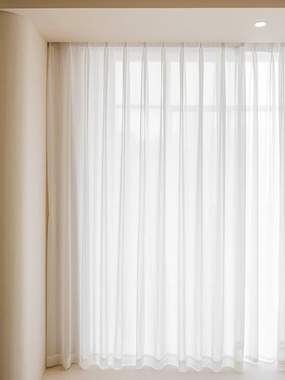 Voile curtains for bedroom in ultra-thin white sheer fabric filtering natural light softly.