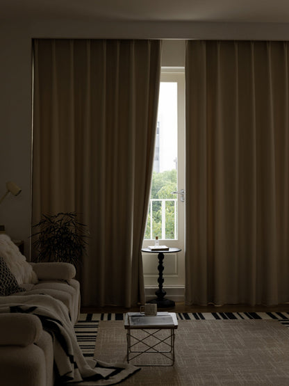 Linen blackout curtains for living room in neutral Morandi palette hanging from ceiling track.