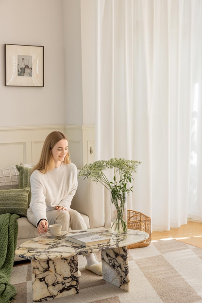 White sheer curtain hanging in a bright room providing privacy and natural light penetration
