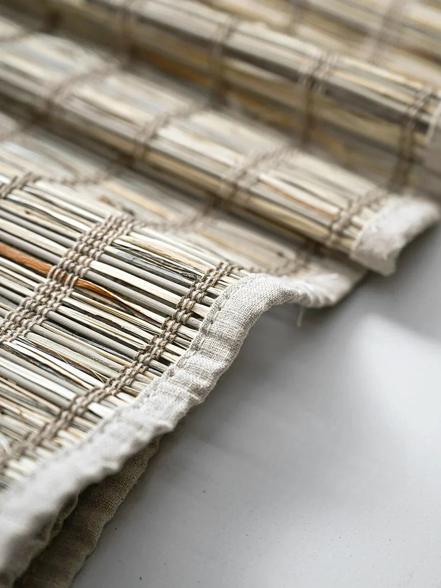 Natural jute bamboo shades with cinnamon tone and textured weave.