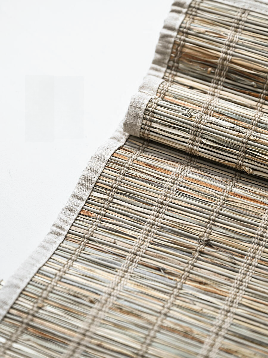 Natural jute bamboo shades outdoor with cinnamon tone, woven Roman style.