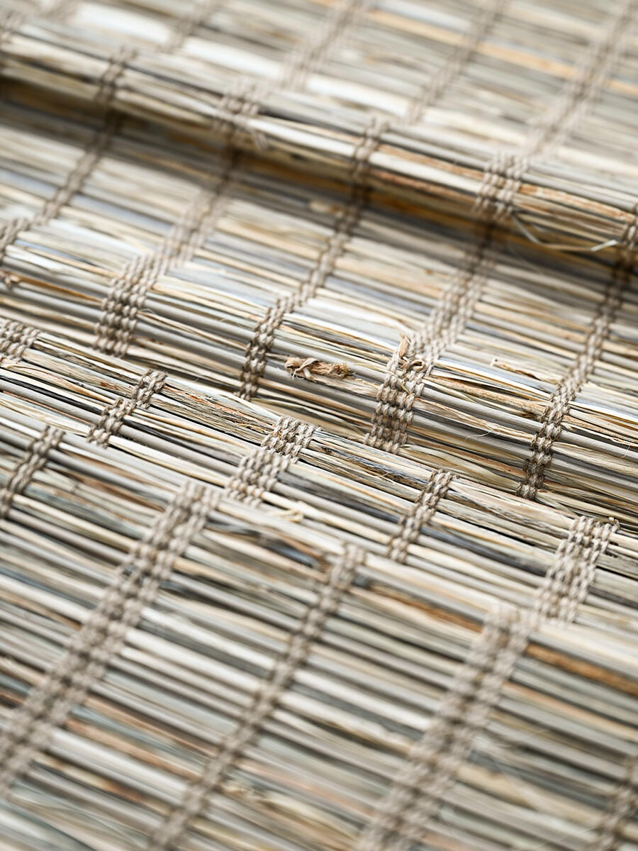 Natural jute bamboo shades outdoor, woven Roman shades in cinnamon tone, showcasing textured craftsmanship.